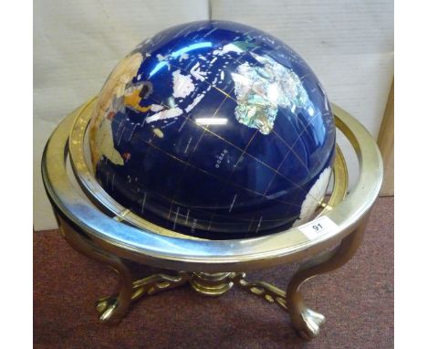 A modern 14'' globe, inlaid with multi-coloured stones and mother-of-pearl, set in a brass tablestand, incorporating a compas