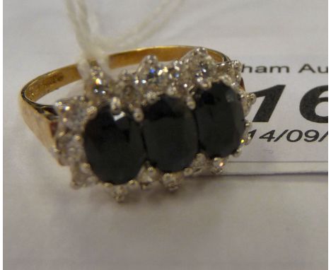 A 9ct gold cluster ring, claw set with cubic zircona and sapphires         11   