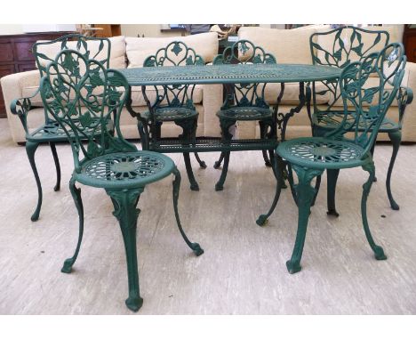 A Victorian style bottle green cast alloy terrace table, raised on twin, tripod supports  29''h  54''L; and a matching set of