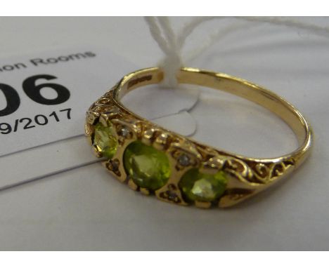 A 9ct gold three stone peridot and diamond set ring         11   