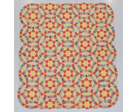 Circa 1930's American Triple Wedding Ring Patterned Quilt, on a yellow cotton ground with coloured patchwork cottons, orange 