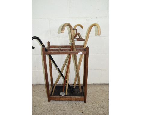 VINTAGE STICK STAND TOGETHER WITH AN ASSORTMENT OF STICKS AND SHOOTING STICK