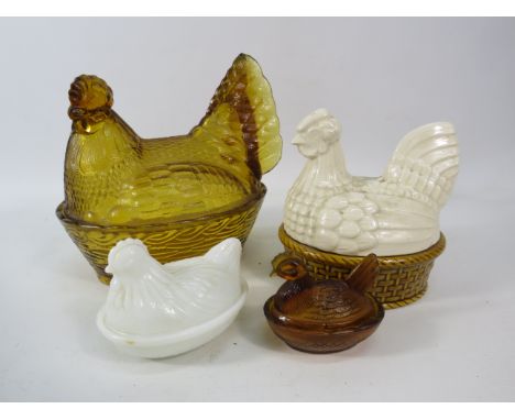 Three glass and one ceramic chicken egg crocks.