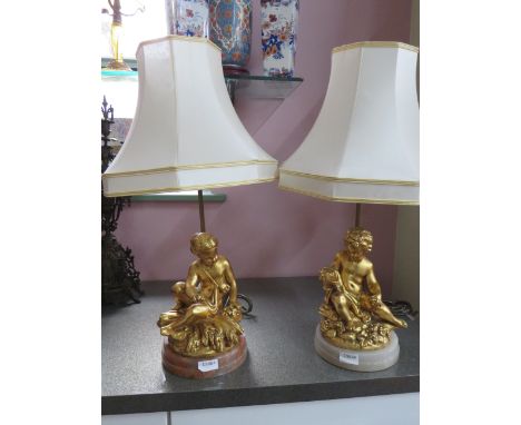 Pair of Gold Painted Spelter Lamp bases featuring Cherub bodies,  Brass light column.  Each raised on a circular marble base.
