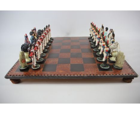 Napololeonic style chess set with plaster pieces. Hand painted Players measure approx 4 inches tall. Board measures approx 18