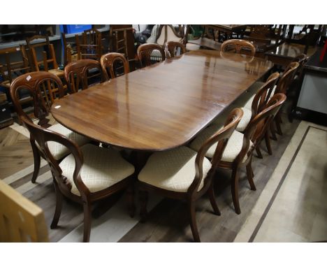 Magnificent Victorian Extending Mahogany Table set on three tripod sections. Comes with Twelve Balloon Back Chairs and two ex