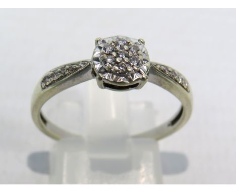9ct White Gold Diamond ring, Seven central diamonds &amp; four to each shoulder .15ct, size R. 2.6 grams
