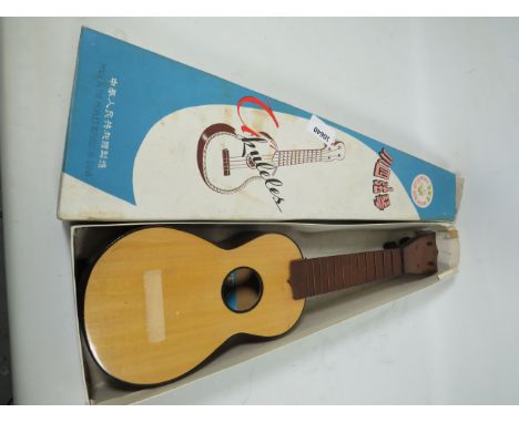 Chinese ukelele with original box, no strings. See photos