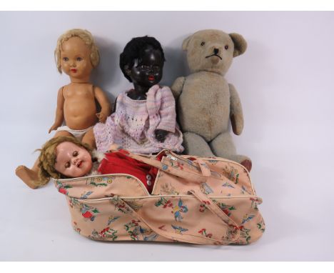 Three vintage dolls and a vintage teddy bear.