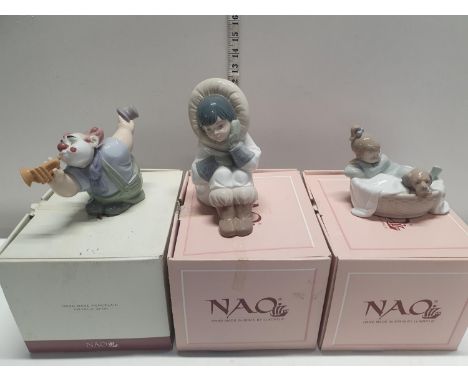 Three boxed NAO figurines 
