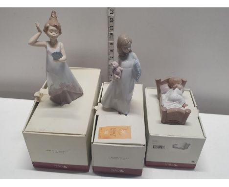 Three boxed NAO figurines 