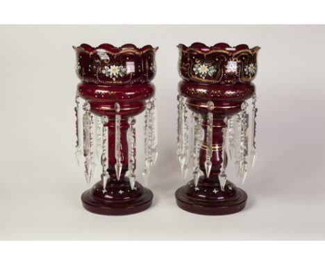 PAIR OF RUBY GLASS TABLE LUSTRES, of typical form, each with twelve prism cut glass drops in two rows, the top enamelled with