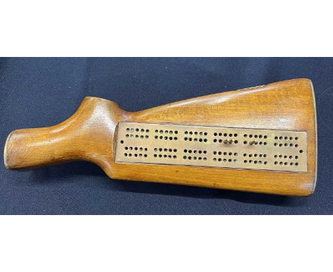 Trench Art; rifle butt with cribbage board inlay mounted on 3 rifle cartridge feet