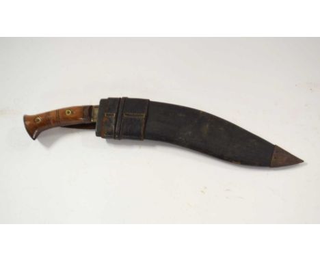 Good quality 20th Century military kukri with turned wooden handle and metal pommel with leather scabbard, length 45cm