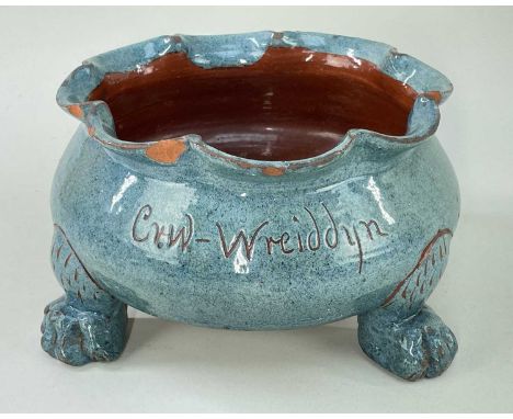 EWENNY POTTERY SHALLOW SEED-PLANTER raised on three paw feet and with lobed rim, in light blue mottled glaze, incise decorati