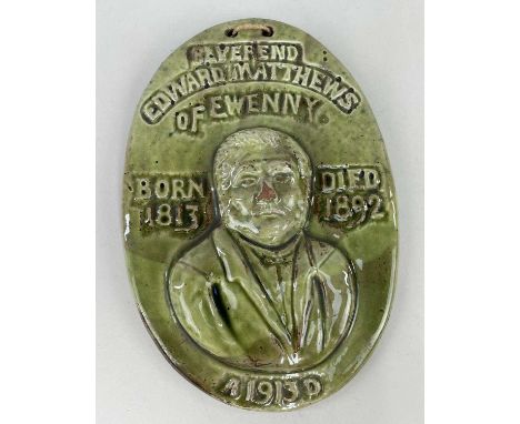 EWENNY POTTERY COMMEMORATIVE PLAQUE in green glaze with raised half-portrait, inscribed 'Reverend Matthews of Ewenny, born 18