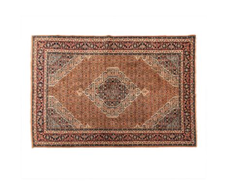 A KURDI CARPET, WEST PERSIA, MODERN the madder-red field with an ivory and blue floral medallion, similar spandrels, all with