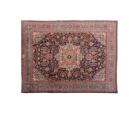 A KHOROSSAN CARPET, PERSIA, MODERN the dark blue field with an ivory and cinnamon floral medallion, sky-blue spandrels, all w