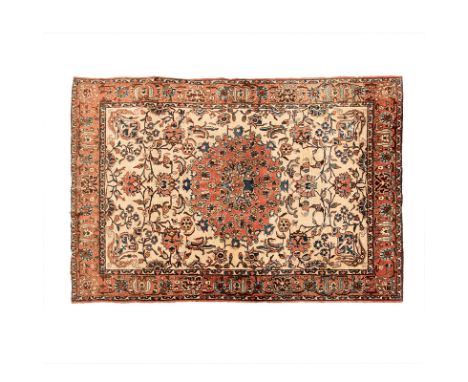 AN ISPHAHAN RUG, PERSIA, CIRCA 1960 the ivory field with a terracotta round floral medallion, all with polychrome flowering v