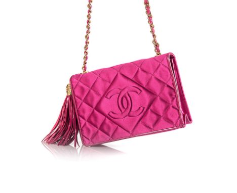 A VINTAGE CHANEL QUILTED SATIN HANDBAG of fuchsia colour, edged in leather with gold metal hardware, an adjustable chain stra