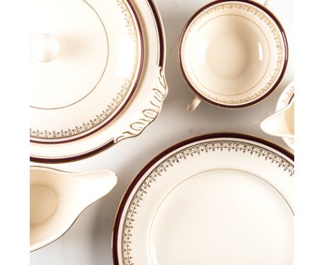 A JOHNSON BROS PART DINNER SERVICE, 20TH CENTURY each with a band of gilt filigree trim and maroon rim against a crème ground