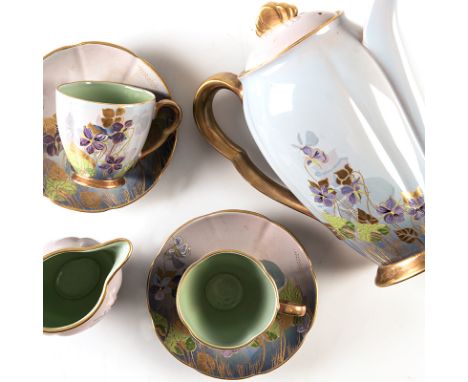 A CARLTON WARE PART COFFEE SERVICE, 20TH CENTURY each hand painted with purple flowers and gilding against a lilac ground, co