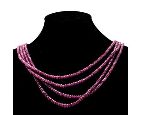 A RUBY BEAD NECKLACE composed of four strands of graduated faceted ruby beads weighing approximately 225cts in total, with an