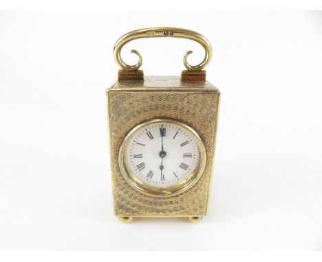 An Edwardian silver gilt miniature travelling clock, Samuel Summers Drew &amp; Ernest Drew, London 1909, engine turned decora