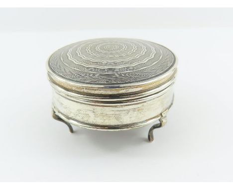 A silver trinket box, Goldsmiths &amp; Silversmiths Co Ltd, London 1913, of circular outline, engine turned decorated hinged 