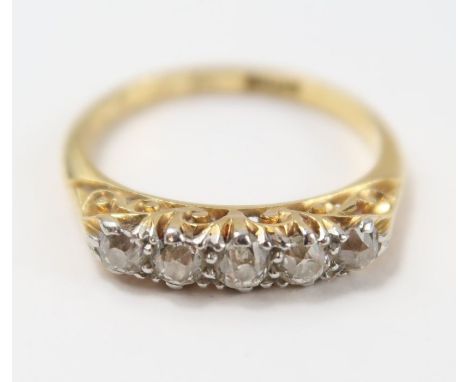 A five stone diamond ring, stamped ‘18ct', the old brilliant cuts estimated as weighing approximately 0.4 carats, finger size