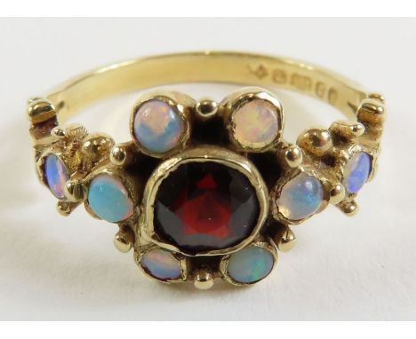 A 9 carat gold opal and garnet dress ring, finger size K, 2.2 g gross