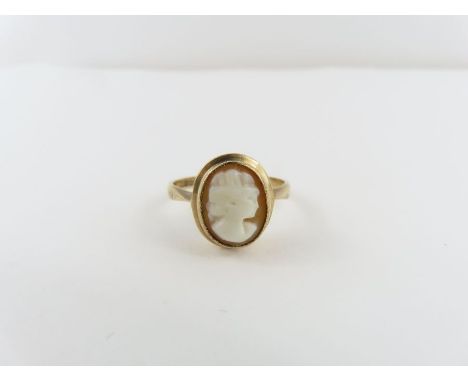 A 9ct gold cameo ring, the oval orange and white cameo with a profile of a lady, finger size P, 2.69g gross