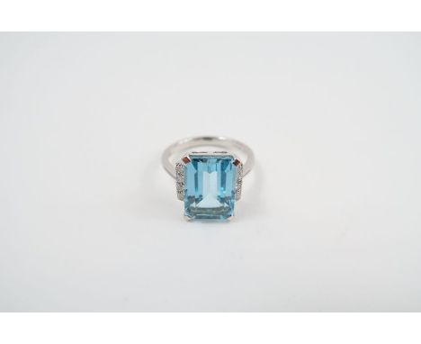 A 9ct white gold blue topaz and diamond dress ring, in the Art Deco style, the rectangular topaz approximately 13.9mm x 9.8mm