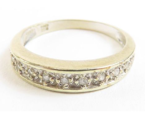 A 9ct gold diamond half eternity, the eleven diamonds illusion set, finger size K 1/2,1.82g gross