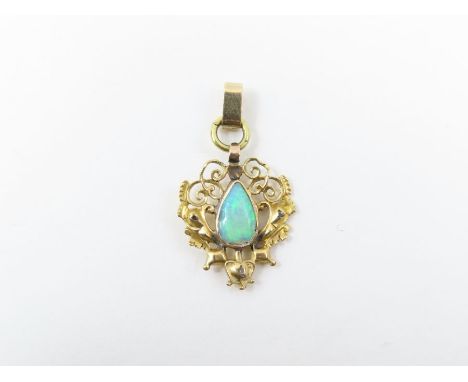 A decorative opal pendant, the pear shaped opal (possibly a doublet) with wire work decoration around it and set with three s