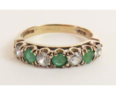 A 9ct gold emerald and white stone seven stone ring, finger size O 1/2, 2.52g gross