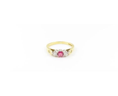 An 18ct gold ruby and white stone three stone ring, the round ruby with a round white stone to each side, and a small diamond