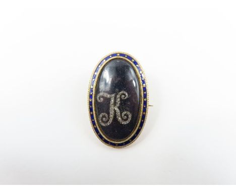 A late 18th century mourning brooch, the glazed panel with a diamond set initial K, with an enamel border, inscription to the