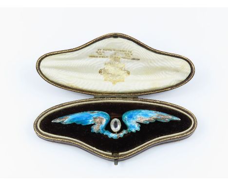 A Child &amp; Child enamel wing brooch, set between the wings is an oval cut pale aquamarine, 9.7 cm across, in a fitted Chil