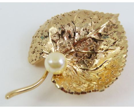 A vintage Christian Dior costume brooch in the form of a leaf with a single simulated pearl, 4.5cm long, marked 'Chr. Dior Ge