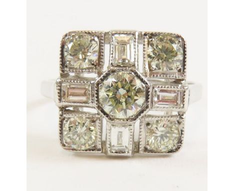 A white gold diamond dress ring in the Art Deco style, indistinctly marked '18ct', the central diamond approximately 4.4mm, a