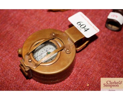 A brass cased marching style compass