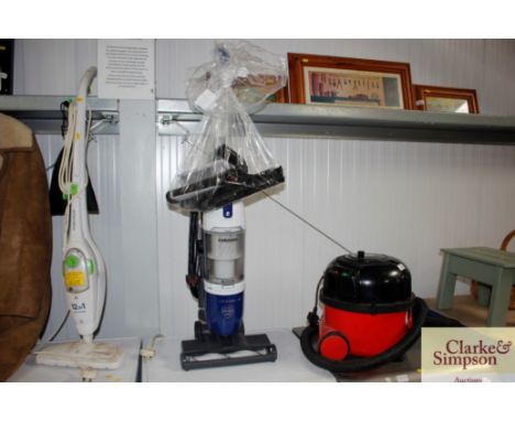 A Samsung Lift and Clean vacuum cleaner with attachments and manual