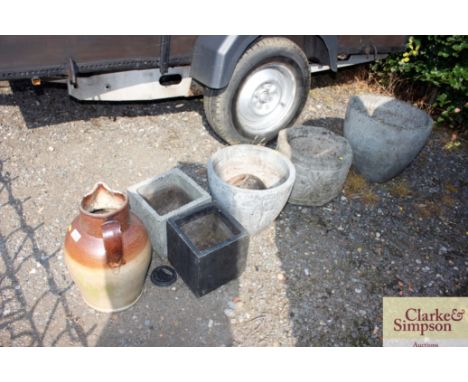 A large earthenware pitcher and various planters 