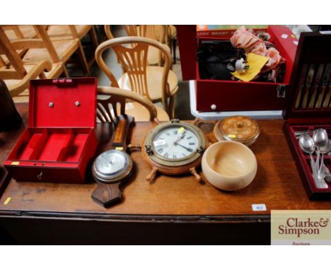 A wall clock in the form of a ships wheel; an oak cased barometer; two wooden bowls and a cash tin