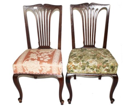 Two Georgian-style mahogany dining chairs with shaped top rail, fret work to the urn shaped splats, upholstered seats, raised