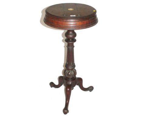 An early Victorian mahogany shaving stand with shaped circular top, twin lift up lids, baluster shaped fluted central support