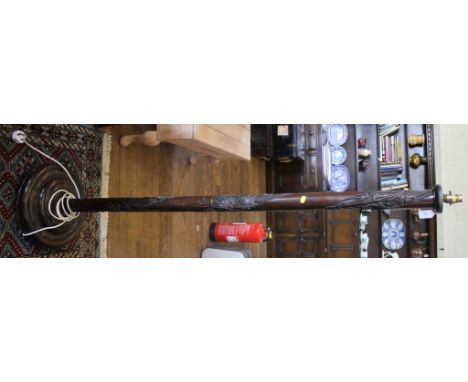 A mid 20th century profusely carved hardwood floor lamp stand on a circular base
