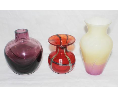 A Mdina Malta glass vase with a trailed abstract design, together with a purple Caithness glass vase and one other (3)