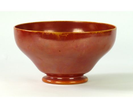 A Ruskin high-fired pedestal bowl
Decorated with an orange lustre glaze, impressed factory marks and complete with original p